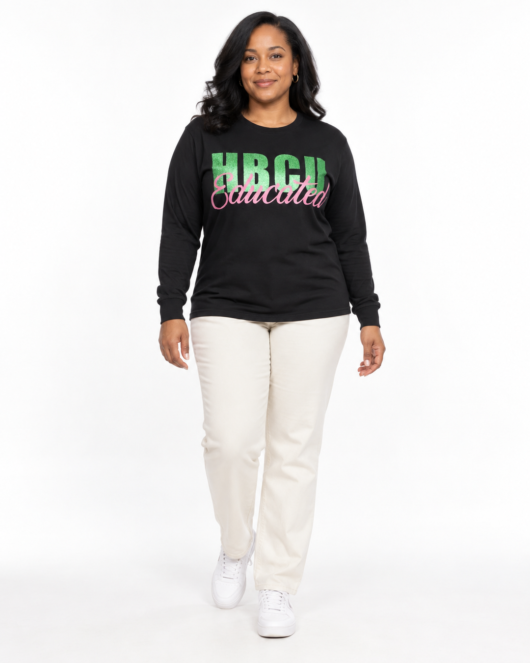 Model wearing a black long-sleeve HBCU Educated Tee with green glitter HBCU lettering and matte pink Educated script.